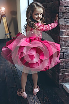 Happy little girl in a beautiful dress.