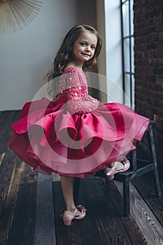 Happy little girl in a beautiful dress.