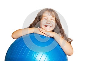 Happy little girl with big fitness ball.