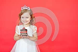 Happy little girl with birthday cake isolated on red background