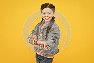 Happy little girl with braids wear denim clothes, cool teen concept