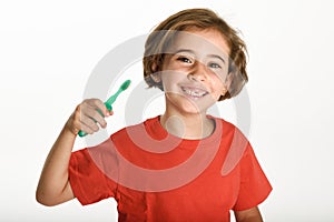 Happy little girl brushing her teeth with a toothbrush