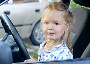 Happy little girl in the car