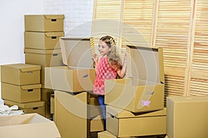 Happy little girl. Cardboard boxes - moving to new house. Moving concept. new apartment. purchase of new habitation