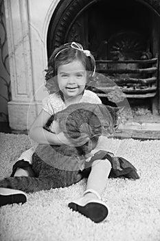 Happy little girl with a cat