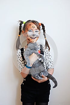Happy little girl with a cat