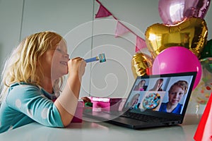 Happy little girl celebrating birthday at home with family on video call