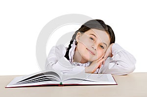 Happy little girl child with a book on white background