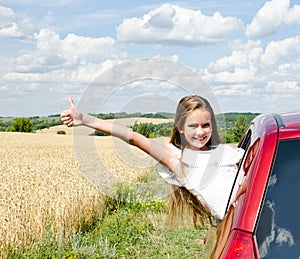 Happy little girl child girl with finger up goes to summer travel trip