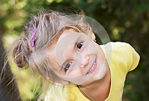 Happy little girl.Child outdoor closeup smiling face.