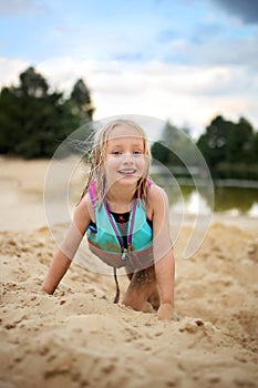 Happy Little Girl Child PLaying on the Sandy Beach Outside