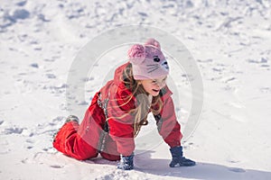 Happy little girl child playing on snow day. Christmas and Happy new year. Smiling kid on winter walk in nature.