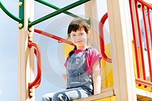 Happy little girl on children playground
