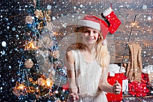 Happy Little girl with Christmas gift box. Cheerful cute Little girl opening a Christmas present. Opening gifts on