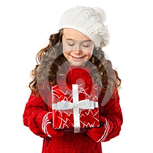 Happy little girl with Christmas gift on isolated white background