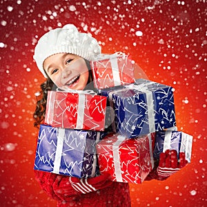 Happy little girl with Christmas gifts, New Year Holidays sale