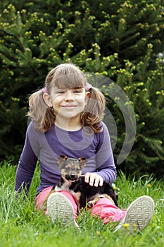 Happy little girl with cute puppy