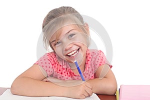 Happy little girl doing homework