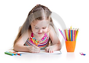 Happy little girl drawing with felt-tip pen in
