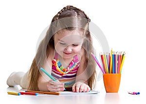 Happy little girl drawing with felt-tip pen in nursery