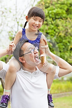 Happy little Girl Eating Ice Cream with father