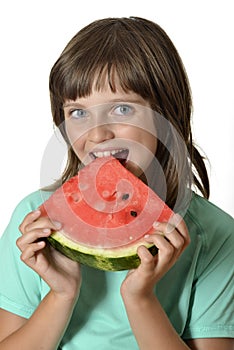 Happy little girl eating melon