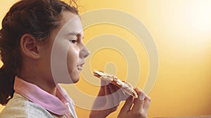 Happy little girl eating a slice of pizza concept. Teenager child hungry eats a slice of pizza lifestyle. Slow motion