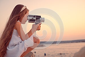 Happy Little Girl Enjoying Sea Sunset and Beach Using Retro Camera