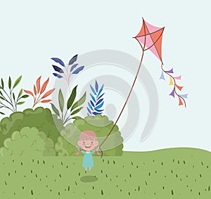 Happy little girl flying kite in the field landscape