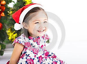 Happy little girl in front of christmas tree