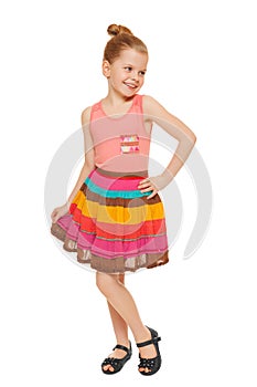 Happy little girl full lenght in colorful skirt, isolated on white background photo