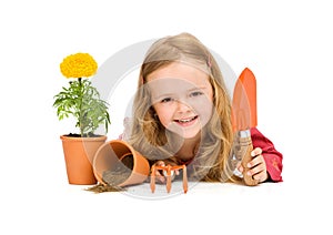 Happy little girl with gardening utensils