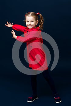 Happy little girl gesturing with her both hands