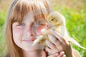 Happy little girl with gosling