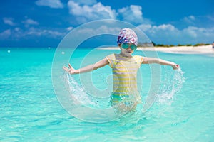 Happy little girl have fun at beach during caribbean vacation