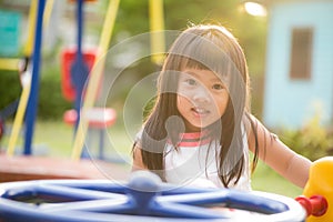 Happy little girl having fun on a playground