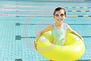 Happy little girl having fun in swimming pool