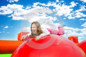 Happy Girl Jumping on Inflate Castle