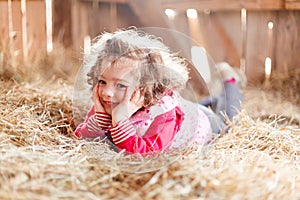 Happy Little Girl in Hay