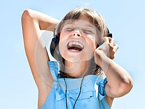 Happy little girl in headphones