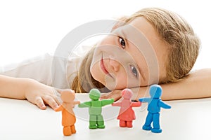 Happy little girl with her colorful clay people