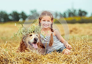 Happy little girl with her dog photo