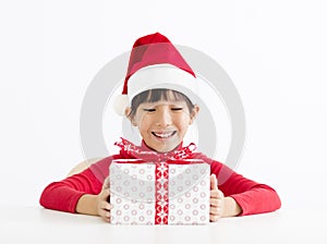 Happy little girl holding Christmas gift