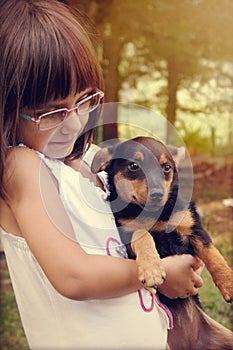 Happy little girl holding her dog