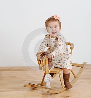 Happy little girl and horse - rocking chair