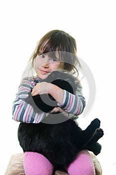 Happy little girl hugging lovely kitten.