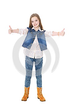 Happy little girl in jeans showing thumbs up