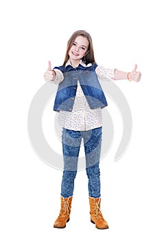 Happy little girl in jeans showing thumbs up