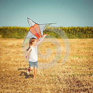 Happy little girl with a kite