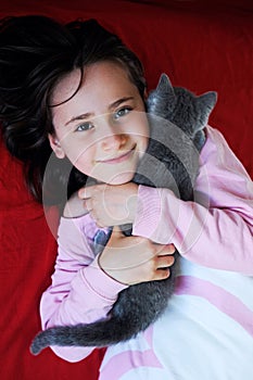 Happy little girl with kitten